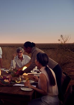 Friends enjoying dinner at Tali Wiru